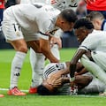 Teammates check on Real Madrid's Brazilian defender #03 Eder Militao (bottom) after he sustained an injury during the Spanish league football match between Real Madrid CF and CA Osasuna at the Santiago Bernabeu stadium in Madrid on November 9, 2024. (Photo by OSCAR DEL POZO / AFP)
