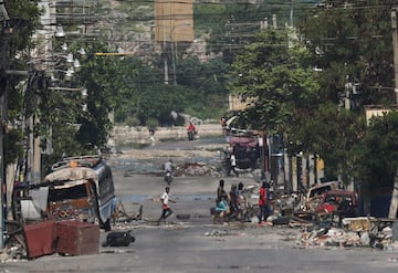 Armed gang members walk through the streets near the presidential palace, in Port-au-Prince, Haiti April 23, 2024.