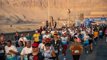 Runners participate in the 32nd Egyptian Marathon as it starts in front of Queen Hatshepsut's temple on the west bank of the Nile river in Egypt's southern city of Luxor on January 10, 2025. (Photo by Khaled DESOUKI / AFP)
