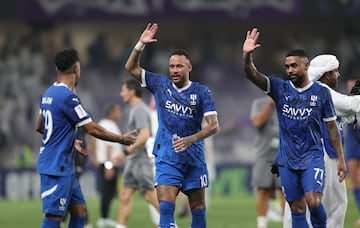 Neymar (L) of Al-Hilal celebrates with his teammates Salem Al-Dawsari (C) and Malcom Filipe de Olevire (R)