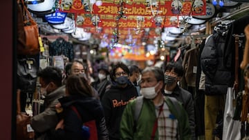 TOKYO, JAPAN - DECEMBER 30: People pass through an indoor arcade in Ameyoko shopping street as they do end of year shopping on December 30, 2021 in Tokyo, Japan. Tokyo Metropolitan Government reported 64 new Covid-19 cases today. However, the governors of Tokyo and Osaka have urged residents to limit New Years Eve gatherings as more cases of the Omicron variant are discovered in the country. (Photo by Carl Court/Getty Images)