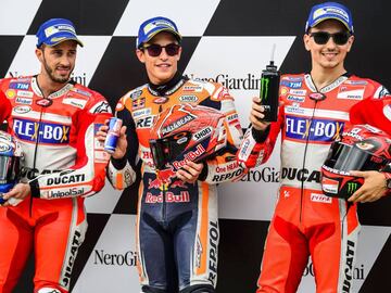 (From L-R) Second placed Andrea Dovizioso of Italy, winner Marc Marquez of Spain and third placed Jorge Lorenzo of Spain pose after the qualifying session of the MotoGP Austrian Grand Prix weekend at Red Bull Ring in Spielberg, Austria on August 12, 2017. / AFP PHOTO / Jure Makovec