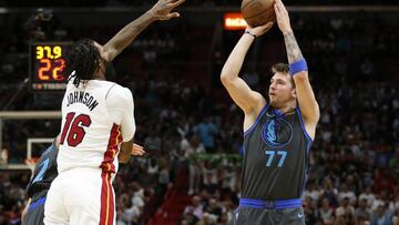 Dallas Mavericks forward Luka Doncic (77) shoots the ball against Miami Heat forward James Johnson (16) during the first half of an NBA basketball game, Thursday, March 28, 2019, in Miami. (AP Photo/Joel Auerbach)