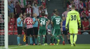 The Athletic players surround referee Tony Chapron on the stroke of half time after he first disallows Iñaki Williams' goal, before awarding the hosts a penalty for a foul on Aritz Aduriz earlier in the move, then finally gives Rapid Vienna a free-kick fo