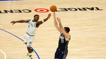 May 22, 2024; Minneapolis, Minnesota, USA; Dallas Mavericks guard Luka Doncic (77) shoots against Minnesota Timberwolves guard Anthony Edwards (5) in the fourth quarter during game one of the western conference finals for the 2024 NBA playoffs at Target Center. Mandatory Credit: Bruce Kluckhohn-USA TODAY Sports