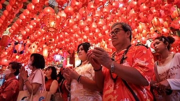 A man prays to gods as part of the traditional worship rituals on the eve of the Lunar New Year at a temple in Chinatown, Bangkok, Thailand January 28, 2025. REUTERS/Chalinee Thirasupa