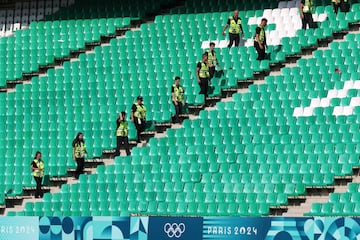 El árbitro suspende el partido a falta de revisión de VAR del segundo gol de Argentina. En la imagen, miembros de la seguridad entre las gradas vacías del estadio.