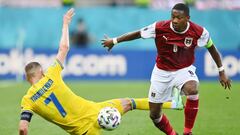 BUCHAREST, ROMANIA - JUNE 21: Andriy Yarmolenko of Ukraine is challenged by David Alaba of Austria during the UEFA Euro 2020 Championship Group C match between Ukraine and Austria at National Arena on June 21, 2021 in Bucharest, Romania. (Photo by Justin 