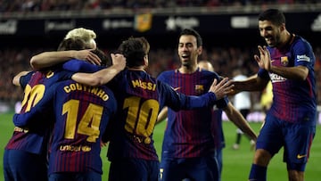 Barcelona players celebrate their opening goal during the Spanish 'Copa del Rey' (King's cup) second leg semi-final football match between Valencia CF and FC Barcelona at the Mestalla stadium in Valencia on February 8, 2018. / AFP PHOTO / J
