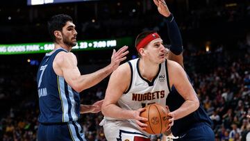 Apr 7, 2022; Denver, Colorado, USA; Denver Nuggets center Nikola Jokic (15) controls the ball as Memphis Grizzlies center Xavier Tillman Sr. (2) and forward Santi Aldama (7) guards in the fourth quarter at Ball Arena. Mandatory Credit: Isaiah J. Downing-USA TODAY Sports