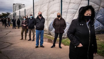 People queue for test for the novel coronavirus COVID-19 during nationwide testing in Bratislava, Slovakia on October 31, 2020. - Slovakia on october 31, 2020 began a programme to screen its entire population for coronavirus but medical professionals have warned it could lead to an increase in cases. Some 45,000 medical workers, army and police are being deployed to carry out the tests in the EU member state of 5.4 million people, collecting swabs at around 5,000 testing points. (Photo by VLADIMIR SIMICEK / AFP)