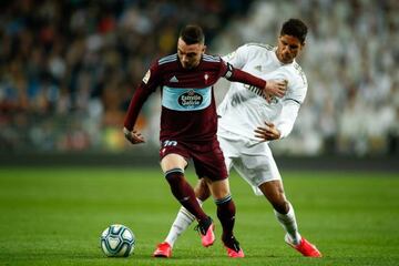 Iago Aspas of RC Celta Vigo takes on Raphael Varane of Real Madrid.