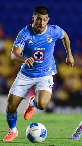 Erik Lira (L) of Cruz Azul fights for the ball with Alejandro Zendejas (R) of America during the Quarter Finals first leg match between America and Cruz Azul as part of the CONCACAF Champions Cup 2025, at Ciudad de los Deportes Stadium on April 01, 2025 in Mexico City, Mexico.