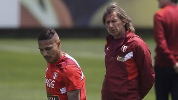 FILE - In this Oct. 1, 2017 file photo, Peru&#039;s national soccer team coach Ricardo Gareca, of Argentina, watches Paolo Guerrero strike a ball during a training session in Lima, Peru. Without any previous experience coaching a national team, Gareca led