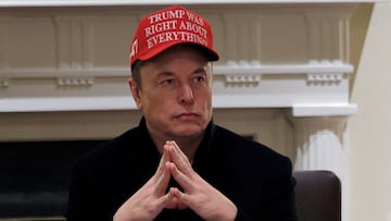 FILE PHOTO: Tesla CEO Elon Musk wears a 'Trump Was Right About Everything!' hat while attending a cabinet meeting at the White House, in Washington, D.C., U.S., March 24, 2025. REUTERS/Carlos Barria/File Photo