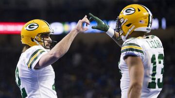 Green Bay Packers wide receiver Allen Lazard (13) and quarterback Aaron Rodgers (12) celebrate together after connecting for a touchdown during the second quarter against the Detroit Lions at Ford Field.