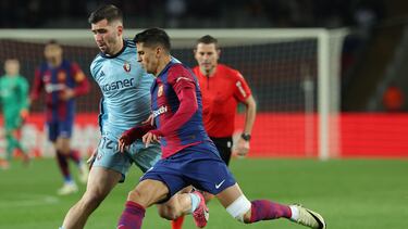Osasuna's Spanish defender #12 Jesus Areso Blanco (L) fights for the ball with Barcelona's Portuguese defender #02 Joao Cancelo during the Spanish league football match between FC Barcelona and CA Osasuna at the Estadi Olimpic Lluis Companys in Barcelona on January 31, 2024. (Photo by LLUIS GENE / AFP)