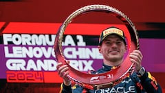 Max Verstappen celebra su victoria en el podio sujetando el trofeo que le acredita como campeón del GP de China de 2024.