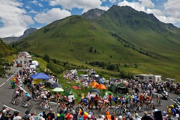 Los espectadores, que encuentran en los bordes de la carretera, animan al pelotón de ciclistas durante la decimocuarta etapa del Tour.