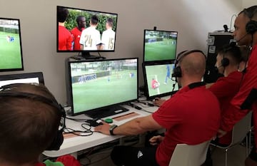 Video Assistant Referees (VAR) watch a practice match as they train in the use of the technology, during a seminar for match officials organised by FIFA ahead of the World Cup in Florence, Italy April 19, 2018.