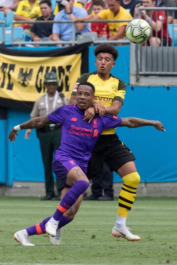 Liverpool's Nathaniel Clyne (R) vies for the ball with Borussia Dortmund's Jadon Sancho during the 2018 International Champions Cup at Bank of America Stadium in Charlotte, North Carolina, on July 22, 2018.  / AFP PHOTO / JIM WATSON