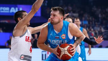 Basketball - FIBA World Cup 2023 - First Round - Group F - Georgia v Slovenia - Okinawa Arena, Okinawa, Japan - August 28, 2023 Slovenia's Luka Doncic in action with Georgia's Rati Andronikashvili REUTERS/Issei Kato