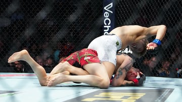 Dec 6, 2025; Las Vegas, Nevada, UNITED STATES; Brandon Moreno (red gloves) fights Tatsuro Taira (blue gloves) during UFC 323 at T-Mobile Arena. Mandatory Credit: Stephen R. Sylvanie-Imagn Images