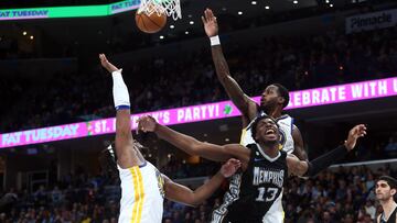 Memphis Grizzlies forward Jaren Jackson Jr. (13) drives to the basket as Golden State Warriors forward Kevon Looney (5) and forward JaMychal Green (1) defend during the second half at FedExForum.