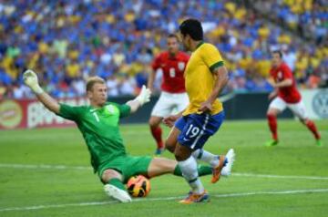 Joe Hart detiene el balon en un mano a mano con Hulk.