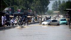 CHARSADDA, PAKISTAN - AUGUST 28: People try to leave the flooded areas after flash flood hit Charsadda district, in northwest, Khyber Pakhtunkhwa province, Pakistan on August 28, 2022. Record monsoon rains were causing a "catastrophe on large scale" as Pakistan has called for international assistance and help in dealing with floods that have killed more than 900 people since June. (Photo by Hussain Ali/Anadolu Agency via Getty Images)