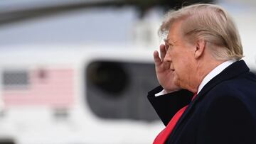 US President Donald Trump walks off  Air Force One after arriving at Andrews Airforce base, Maryland on December 31, 2020. 