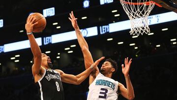 Dec 26, 2018; Brooklyn, NY, USA; Brooklyn Nets guard Spencer Dinwiddie (8) goes up for a shot while being defended by Charlotte Hornets guard Jeremy Lamb (3) during the second overtime at Barclays Center. Mandatory Credit: Andy Marlin-USA TODAY Sports