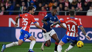 Athletic Bilbao's Spanish forward #11 Nico Williams fights for the ball with Girona's Spanish defender #25 Eric Garcia and Girona's Spanish midfielder #14 Aleix Garcia during the Spanish league football match between Girona FC and Athletic Club Bilbao at the Montilivi stadium in Girona on November 27, 2023. (Photo by Josep LAGO / AFP)