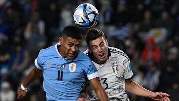 Uruguay's forward Juan De Los Santos (L) and Italy's defender Riccardo Turicchia jump for the ball during the Argentina 2023 U-20 World Cup final match between Uruguay and Italy at the Estadio Unico Diego Armando Maradona stadium in La Plata, Argentina, on June 11, 2023. (Photo by Luis ROBAYO / AFP)