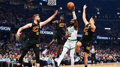 Dean Wade #32, Caris LeVert #3 and Georges Niang #20 of the Cleveland Cavaliers guard Jaylen Brown #7 of the Boston Celtics during the second quarter at Rocket Mortgage Fieldhouse on March 05, 2024 in Cleveland, Ohio.