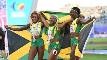 Gold medalist Shelly-Ann Fraser-Pryce (C), silver medalist Shericka Jackson (R) and bronze medalist Elaine Thompson-Herah (L) celebrate after the Women's 100m Final during the 18th edition of the World Athletics Championships at Hayward Field in Eugene, Oregon, United States on July 17, 2022.