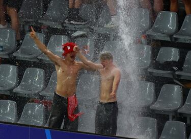 Soccer Football - Euro 2024 - Round of 16 - Germany v Denmark - Dortmund BVB Stadion, Dortmund, Germany - June 29, 2024  Denmark fans are rained on in the stands as the match is stopped due to adverse weather conditions REUTERS/Bernadett Szabo