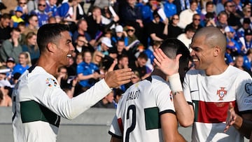 Portugal's forward Cristiano Ronaldo (L) celebrates with teammate Portugal's Pepe (R) after scoring the 0-1 goal during the UEFA Euro 2024 group J qualification football match between Iceland and Portugal in Reykjavik on June 20, 2023. (Photo by Halldor KOLBEINS / AFP)