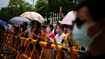Parents wearing face masks wait for students outside a venue of the annual national "gaokao" university entrance exam, which was postponed in the city due to the coronavirus disease (COVID-19) outbreak, in Shanghai, China July 7, 2022. REUTERS/Aly Song