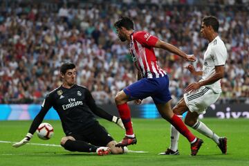 Real Madrid's Thibaut Courtois makes a save against Atletico Madrid's Diego Costa