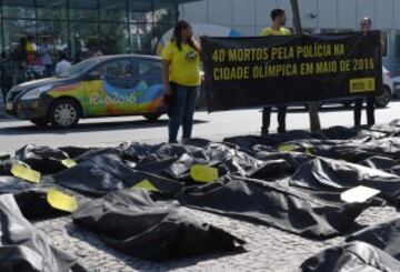 Miembros de Amnistía Internacional (AI) se manifestaron en frente del Comité Olímpico Internacional en Río para pedir justicia tras la muerte de 40 personas, supuestamente por violencia policial, en el mes de mayo.