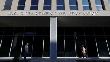 FILE PHOTO: People walk in front of the Department of Education building, amid reports that U.S. President Donald Trump's administration will take steps to defund the federal Education Department, in Washington, U.S., February 4, 2025. REUTERS/Kevin Lamarque/File Photo