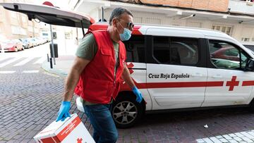 MADRID, SPAIN - APRIL 24: Red Cross volunteers are seen handing out food to families in need on April 24, 2020 in Madrid, Spain. Starting last week, some businesses deemed non-essential have been allowed to resume operations, and it is expected that from April 26 children under 14 will be allowed to come and go from their homes more freely. Spain has had more than 219,000 confirmed cases of COVID-19 and over 22,000 reported deaths, although the rate has declined after weeks of lockdown measures. (Photo by David Benito/Getty Images)