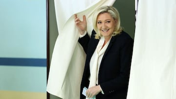 French far-right party Rassemblement National (RN) presidential candidate Marine Le Pen leaves a polling booth during the second round of France's presidential election at a polling station in Henin-Beaumont, northern France, on April 24, 2022. (Photo by Thomas SAMSON / AFP)