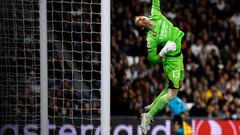Real Madrid's Ukrainian goalkeeper #13 Andriy Lunin dives to save the ball during the UEFA Champions League first round group C football match between Real Madrid CF and SSC Naples at the Santiago Bernabeu stadium in Madrid on November 29, 2023. (Photo by OSCAR DEL POZO / AFP)