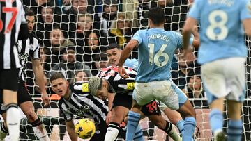 Newcastle United's Brazilian midfielder #39 Bruno Guimaraes (C) clears the ball under pressure from Manchester City's Spanish midfielder #16 Rodri during the English Premier League football match between Newcastle United and Manchester City at St James' Park in Newcastle-upon-Tyne, north east England on January 13, 2024. (Photo by Oli SCARFF / AFP) / RESTRICTED TO EDITORIAL USE. No use with unauthorized audio, video, data, fixture lists, club/league logos or 'live' services. Online in-match use limited to 120 images. An additional 40 images may be used in extra time. No video emulation. Social media in-match use limited to 120 images. An additional 40 images may be used in extra time. No use in betting publications, games or single club/league/player publications. /