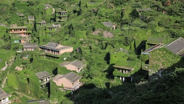 ZHOUSHAN, CHINA - MAY 20: Houses covered with tendril climbing plants are seen at the deserted Houtouwan village on Shengshan island on May 20, 2020 in Zhoushan, Zhejiang Province of China. The village in East China has become a tourist spot for its natural ecology and fine views. (Photo by Chen Yongjian/VCG via Getty Images)