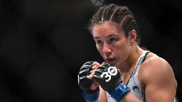 Mexico's mixed martial arts fighter Alexa Grasso fights Kyrgyzstan's mixed martial arts fighter Valentina Shevchenko (out of frame) during their UFC 285 women's flyweight title bout at T-Mobile Arena, in Las Vegas, Nevada, on March 4, 2023. (Photo by Patrick T. Fallon / AFP)