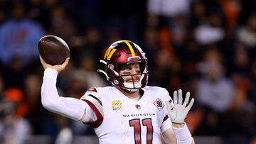 CHICAGO, ILLINOIS - OCTOBER 13: Carson Wentz #11 of the Washington Commanders looks to pass during the second quarter against the Chicago Bears at Soldier Field on October 13, 2022 in Chicago, Illinois.   Michael Reaves/Getty Images/AFP