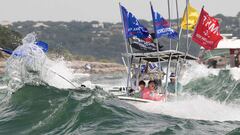 A boat is engulfed in waves from the large wakes of a flotilla of supporters of U.S. President Donald Trump, during a boat parade on Lake Travis near Lakeway, Texas, U.S. September 5, 2020.  Bob Daemmrich via REUTERS NO RESALES. NO ARCHIVES. MANDATORY CRE